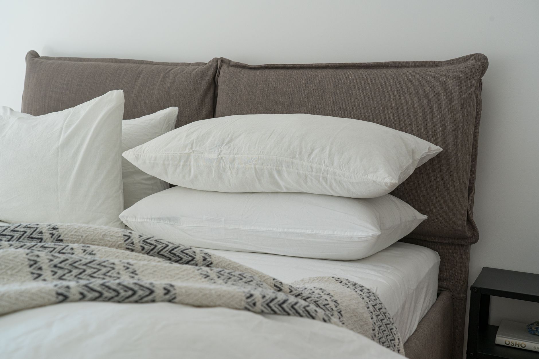 Layered bedding on a neatly made bed